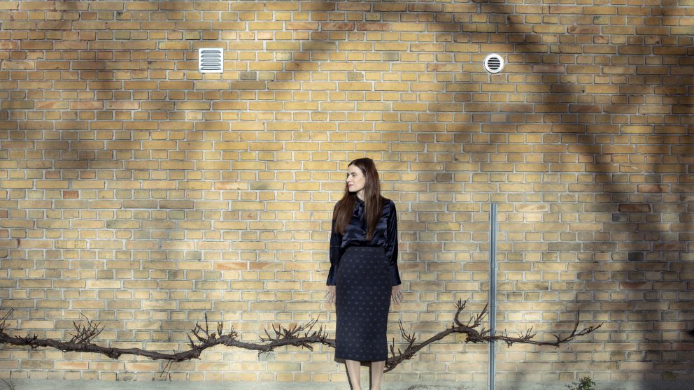 Portrait of Sahra-Josephine Hjorth against a brick wall